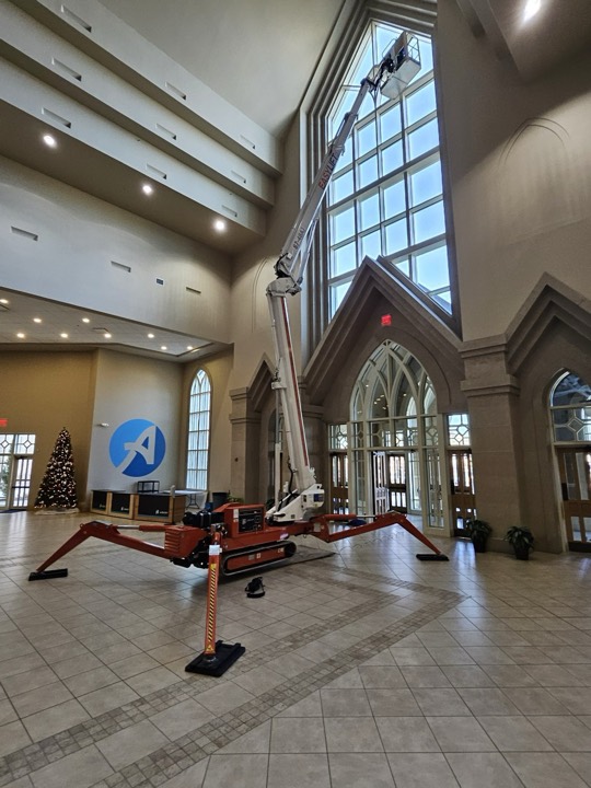A Sapphire lift reaching a tall window in a large hall