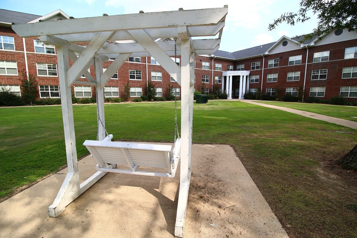 A porch swing in front of Armstrong Hall at Harding University in Searcy