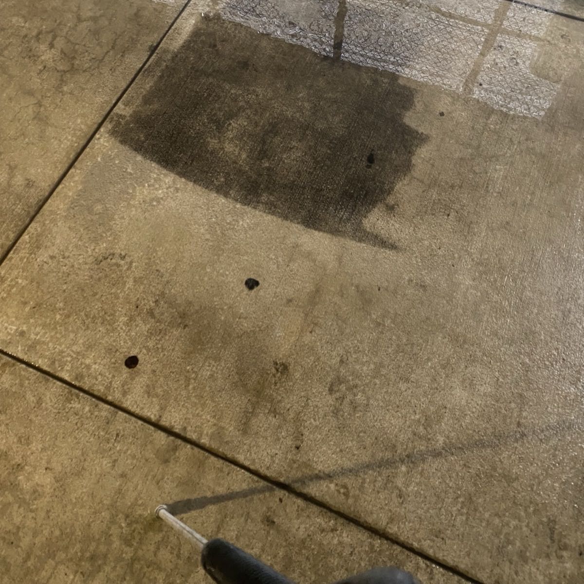 Concrete half pressure washed, showing the difference